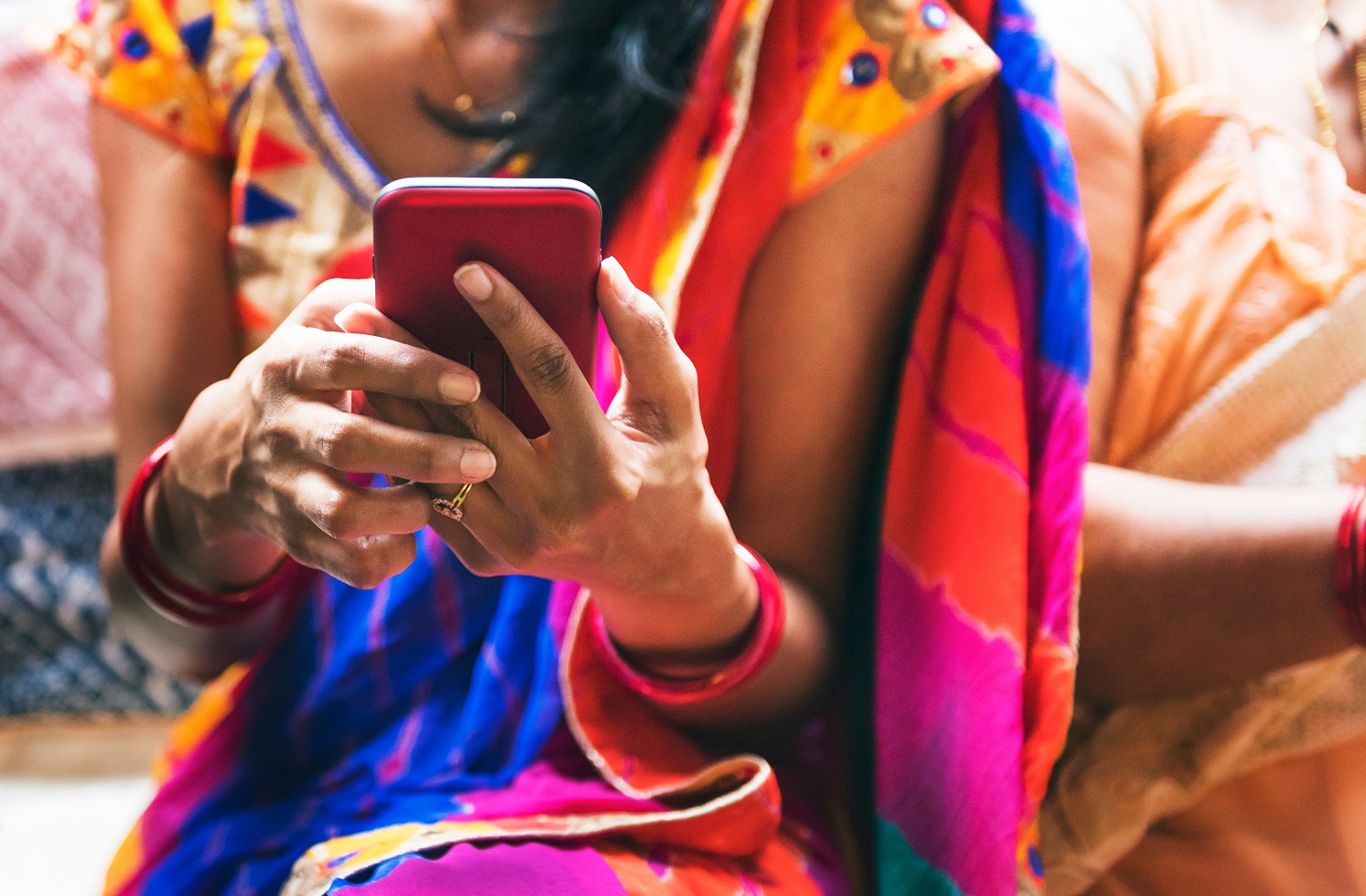 Image of woman from Southeastern country using phone