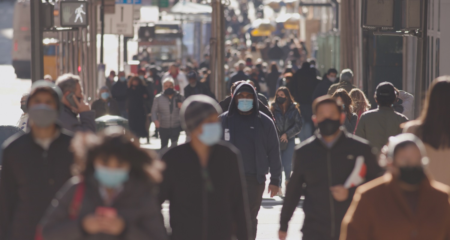 Image of people walking with masks. 