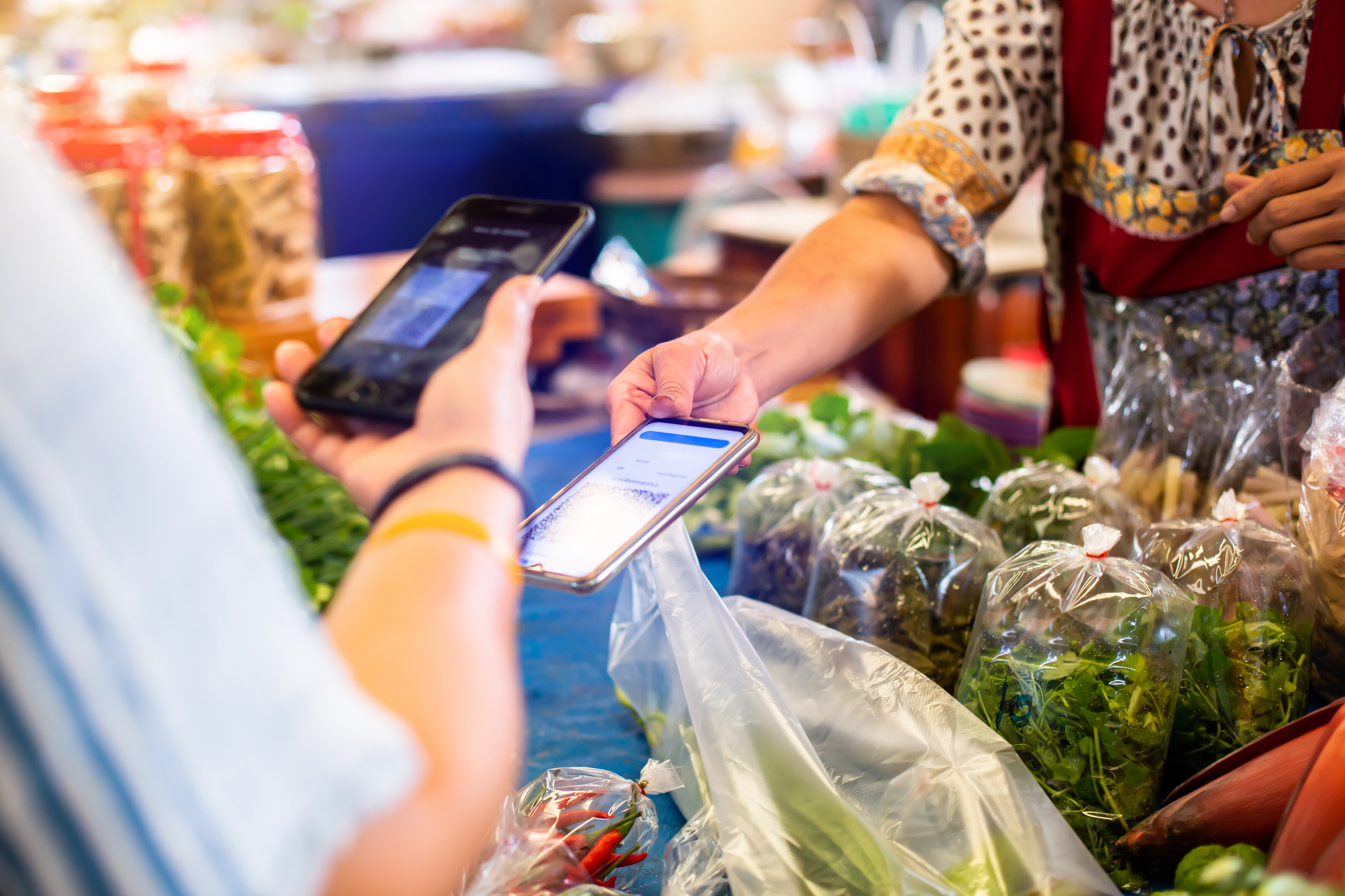shopper purchasing produce with digital payment