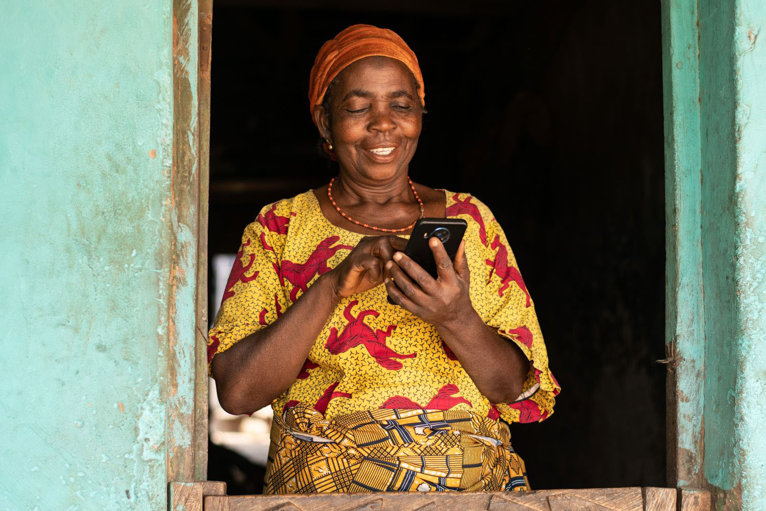 smiling elderly woman using her phone