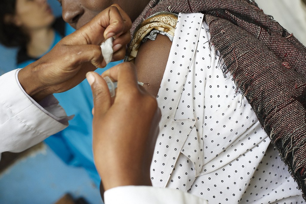 Woman in Ethiopia receives a vaccine shot