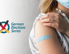 An image of a woman with a Covid vaccine band aid. 