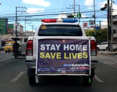 Back of a truck in the Philippines that says "Stay home, saved live"
